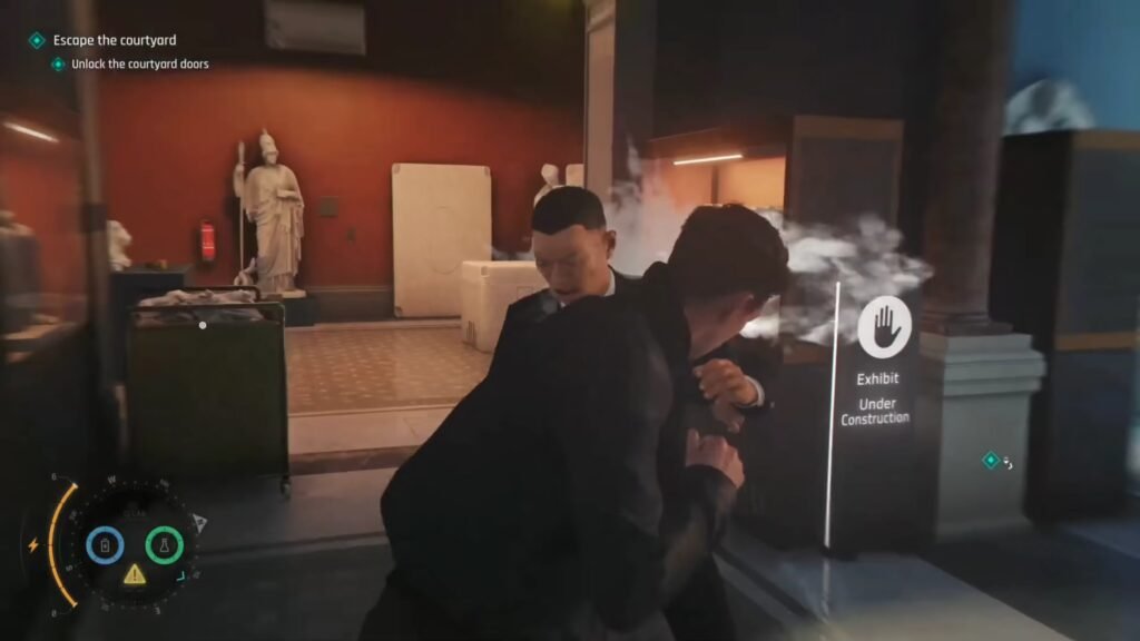007 First Light New Exclusive Gameplay Demo 1-51 screenshot - GamersPack ישראל First-person view inside a museum lobby with two people, one adjusting the other, and a sign reading 007 First Light New Exclusive Gameplay Demo 1-51 screenshot'Exhibit Under Construction' nearby, steam in the air.