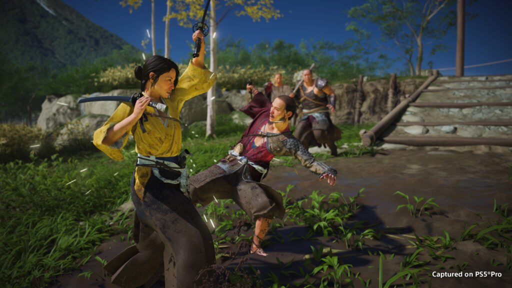 Ghost Most Wanted DISCLAIMER frame 4 - GamersPack ישראל A woman in a yellow shirt raises a sword at a man in brown leather armor during a muddy outdoor fight, with two figures watching in the background. Ghost Most Wanted DISCLAIMER frame 4