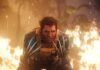 Wolverine-like superhero crouching forward with claws extended amid flames and smoke at close range.