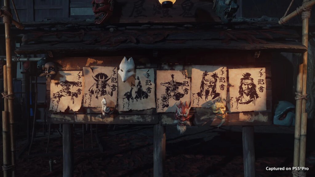 ghost of yotei complete edition 3 - GamersPack ישראל Dim display of parchment scrolls with black ink portraits and carved masks on a weathered wooden stall, lit warmly from below (folklore theme). ghost of yotei complete edition 3
